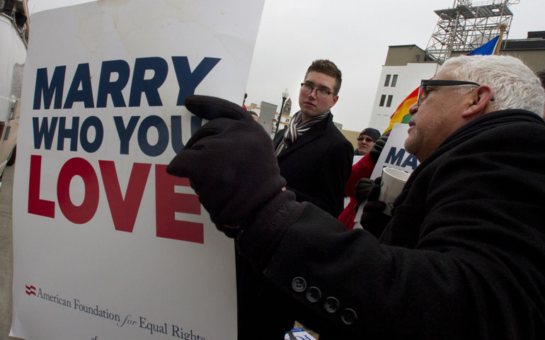 Spencer Geiger, left, and Roger Roman, both of Virginia Beach, Va., demonstrate on Feb. 4 in support of marriage equality as Norfolk Federal Court holds a hearing on the constitutionality of Virginia's ban on same-sex marriage. (Newscom/MCT/Adrin Snider)
