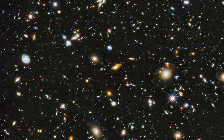 Astronomers using NASA's Hubble Space Telescope have assembled a comprehensive picture of the evolving universe. The Hubble Ultra Deep Field 2014 image (a portion is shown here) contains approximately 10,000 galaxies, extending back in time to within a few hundred million years of the Big Bang. (NASA)