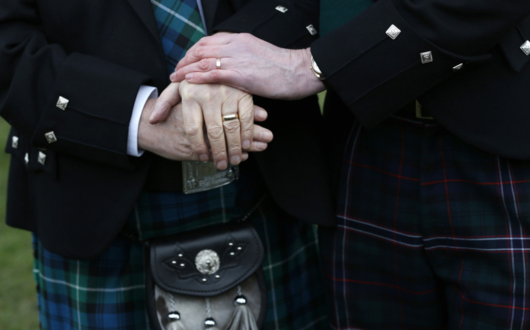 Larry Lamont and Jerry Slater take part in a symbolic same-sex marriage ceremony Tuesday outside the Scottish Parliament in Edinburgh. (CNS/Reuters/Russell Cheyne)