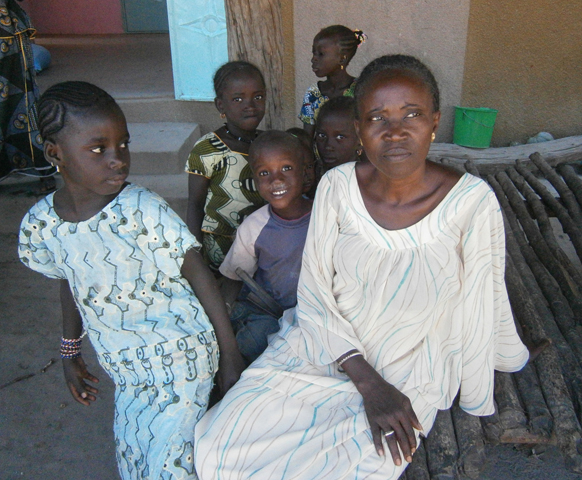 Senegalese aid worker Constance Mbaye sits with children Dec. 11 in the village of Dialamakhan, Senegal. Mbaye, a Catholic, works to help rural women get an education. (CNS/James Martone)