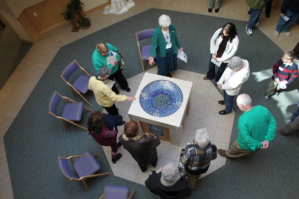 At a special open house during National Catholic Sisters Week, Sr. Ruth Ann, top center, introduces "Sister Water," the central holy water font, to guests of the Sisters of St. Francis of the Holy Cross Motherhouse. (Courtesy of Sisters of St. Francis of the Holy Cross)