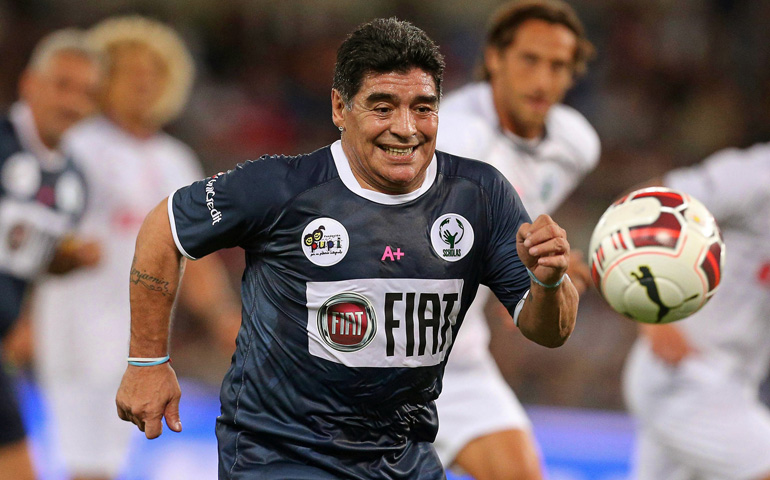 Argentine soccer legend Diego Maradona races for the ball during the interreligious "Match for Peace" Monday at Rome's Olympic Stadium. (CNS/EPA/Allesandro Di Meo)