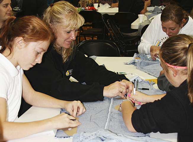 Students at Spalding Catholic School in Granville, Iowa, trace, cut and put fabric pieces in shoe sets for children in Africa on Oct. 22. (CNS/Globe/Renee Webb)