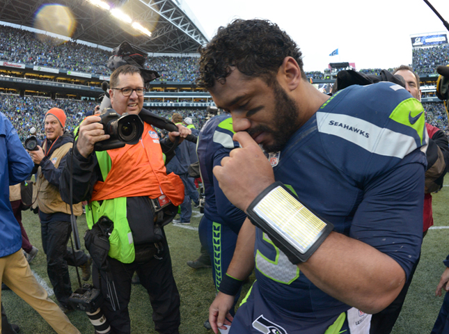 Seattle Seahawks quarterback Russell Wilson bows his head in prayer after the overtime victory over the Green Bay Packers in the NFC Championship Game on Jan. 18 at CenturyLink Field. The Seahawks defeated the Packers 28-22 in overtime. (RNS/Reuters/USA Today/Kirby Lee)
