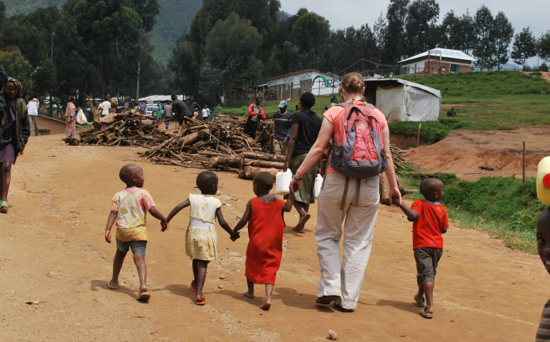 Erin McDonald walks with friends at Kiziba Refugee Camp in Rwanda, 2012. (Provided photo)