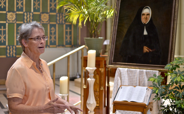 Sr. Michele Dvorak, president of the order's Ancilla College in Donaldson, Indiana, next to a portrait of Blessed Catherine Kasper (GSR photo / Dan Stockman)
