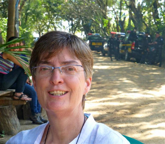 Sr. Dani Brought accompanies resisters outside the gold mine at La Puya. Armed police are a constant, intimidating presence. (Mary Jo McConahay)