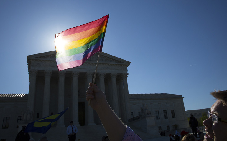A supporter for same-sex marriage stands outside the U.S. Supreme Court on April 28 in Washington. (CNS/Tyler Orsburn) 