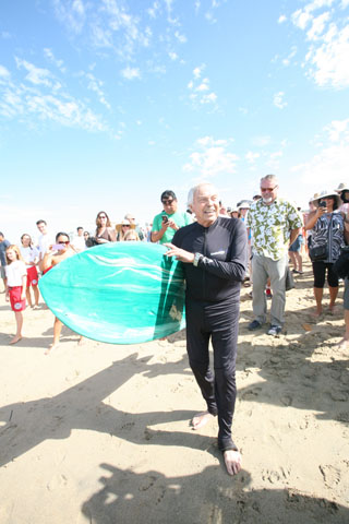 Fr. Christian Mondor heads toward the ocean at the Blessing of the Waves Sept. 7. (Orange, Calif., diocese)