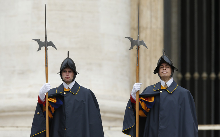 Swiss Guards stand at attention as Pope Francis leads his Sept. 24 general audience in St. Peter's Square at the Vatican. (CNS/Paul Haring)