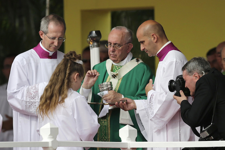 Pope Francis gives Communion at the end of the first mass of his visit to Cuba in Havana’s Revolution Square, Sept. 20, 2015. (Reuters/Claudia Daut)