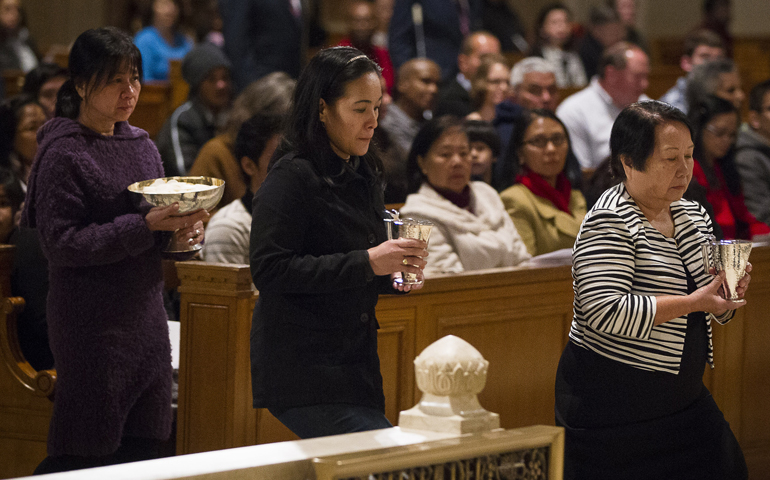 Survivors of human trafficking carry offertory gifts during at Mass celebrated Sunday at the Basilica of the National Shrine of the Immaculate Conception in Washington to mark the International Day of Prayer and Awareness Against Human Trafficking. (CNS/Tyler Orsburn) 