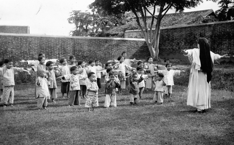 Sr. Mary Colombiere Bradley does morning exercises with orphan girls in Loting, China, in May 1937 (Maryknoll archives)