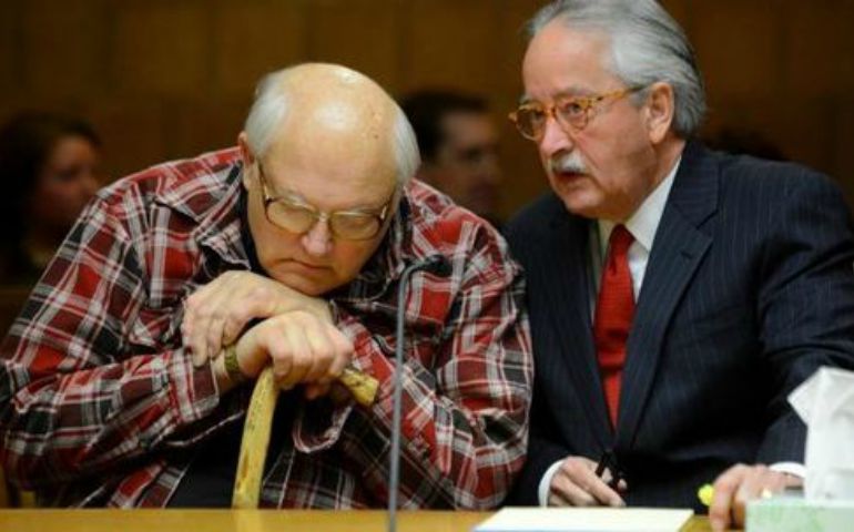 Fr. Jonathan Wehrle, left, and his attorney, Lawrence Nolan, consult during a July 7 hearing. (Courtesy of Lansing State Journal)