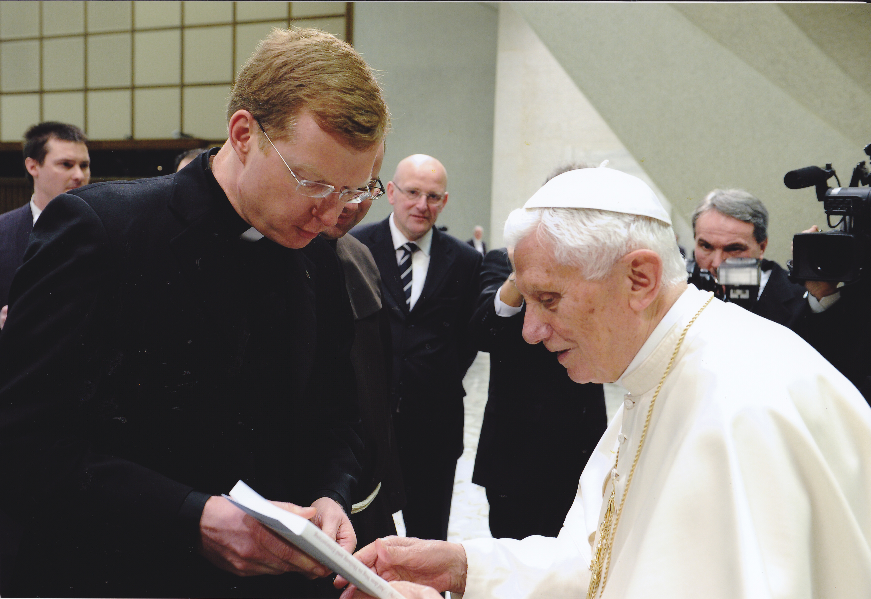 Jesuit Fr. Hans Zollner presents the acts of a 2012 symposium on sex abuse to Pope Benedict XVI on Feb. 1