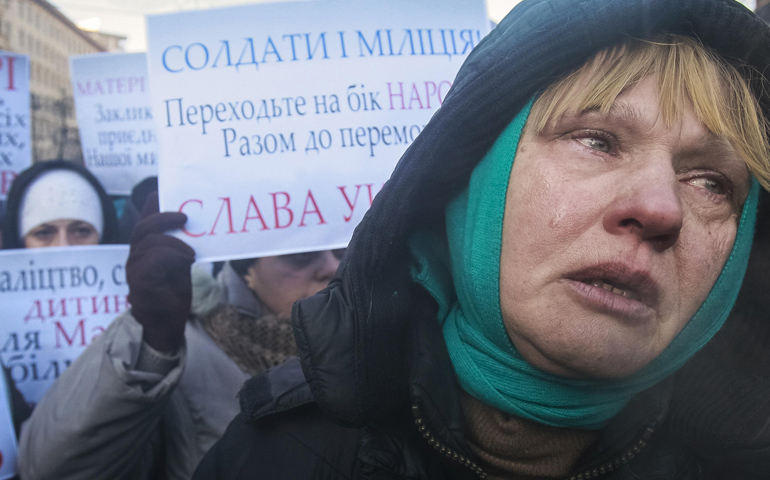 A woman cries as she and others appeal to Ukrainian police troops at the site of clashes with protesters Jan. 24 in Kiev. (CNS/Reuters/Gleb Garanich)