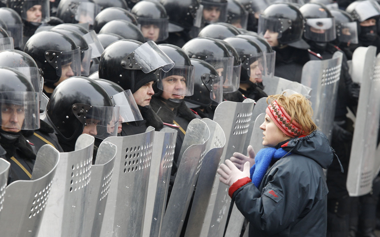 A woman addresses riot police holding shields during a rally held by pro-European Union protesters Tuesday in Kiev, Ukraine. (CNS/Reuters/Vasil y Fedosenko)