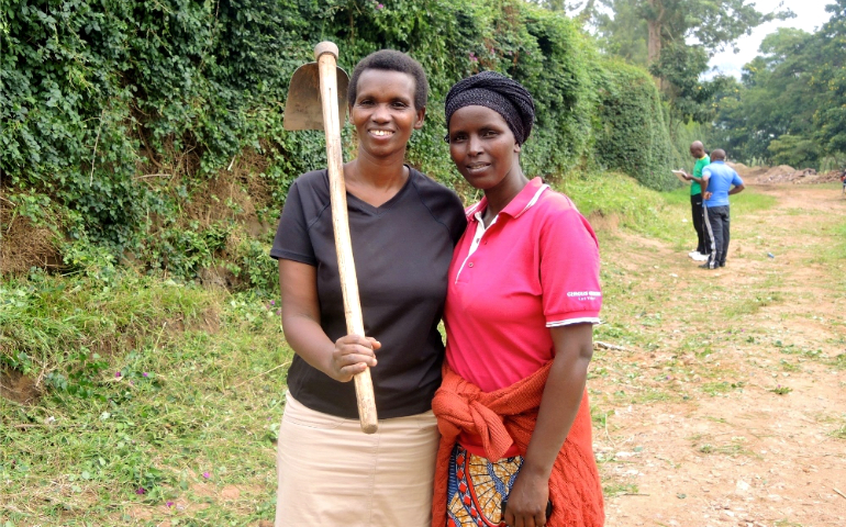Yvonne Nshuti, left, poses with a neighbor during the monthly Umuganda community service day in Kigali, Rwanda. (GSR photo/Melanie Lidman)