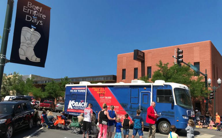 The Kris Kobach campaign bus rolls through downtown Garden City during a Beef Empire Days parade on June 10. (GSR photo / Dawn Araujo-Hawkins)