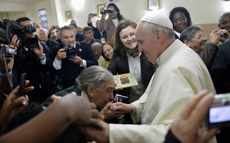 Pope Francis greets residents at the chapel Thursday in the Varginha community of Rio de Janeiro. (CNS/Reuters)