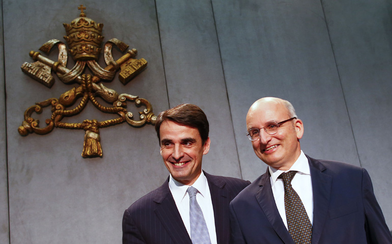 Jean-Baptise de Franssu, left, the new president of the Vatican bank, and outgoing president Ernst Von Freyberg pose during a news conference Wednesday at the Vatican. (CNS/Reuters/Tony Gentile)