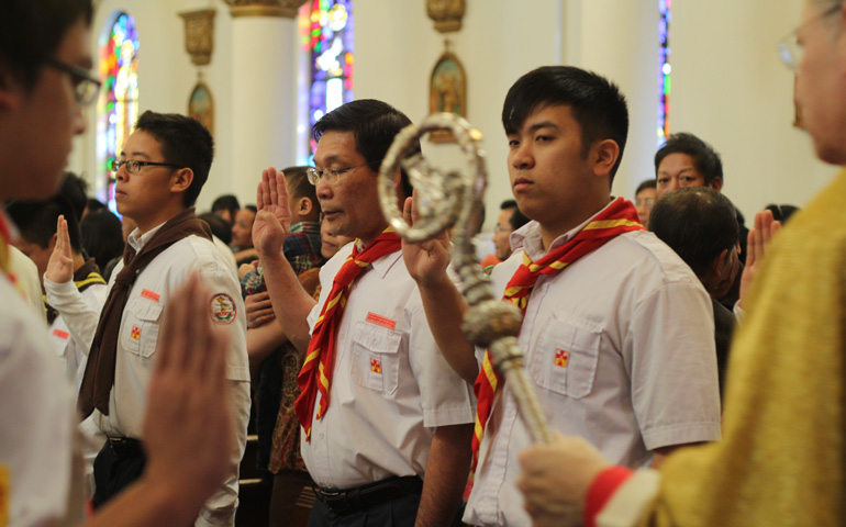 Members of Anredunglac, the Vietnamese Eucharistic Youth Society of America, form a line as Bishop Robert Finn prepares to lead a procession at the beginning of the Mass. (NCR photos/Eloisa Perez-Lozano)