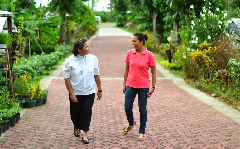Sr. Lydia Collado, left, a Religious of the Sacred Heart works to create relationship in the community of volunteers at Sophie’s Farm, one of the places where she ministers in Northern Samar, Philippines. (Syd Baradi)