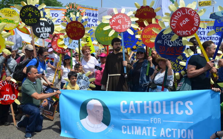 Catholics carrying banners bearing messages from Pope Francis' environmental encyclical 'Laudato Si' ' gather outside St. Dominic Church in Washington, D.C., April 29 ahead of the People's Climate March. (GCCM photo / Victoria Pizzini)