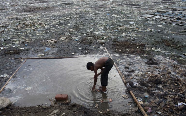A boy washes himself in a polluted pond in the Hazaribagh area of Dhaka, Bangladesh, in 2014. The Hazaribagh area, widely known for its tannery industry, is considered one of the most polluted places on earth. (Newscom/ZUMA Press/Probal Rashid)