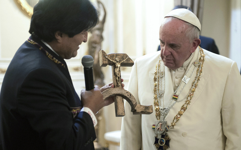 Bolivian President Evo Morales presents a gift of a wooden hammer and sickle -- the symbol of communism -- with a figure of a crucified Christ to Pope Francis at the government palace in La Paz, Bolivia, on Thursday. (CNS/L'Osservatore Romano )