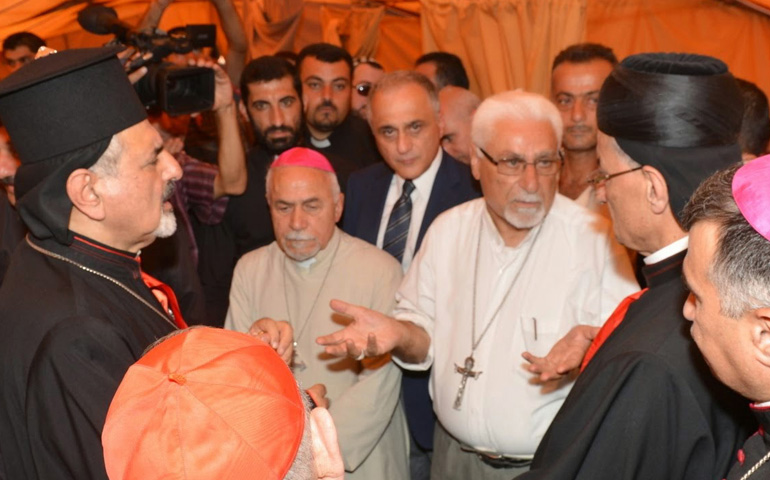 Syriac Catholic Patriarch Ignace Joseph III Younan, left, speaks to other Christian leaders during an Aug. 20 visit to Iraqi refugees in Irbil, Iraq. (CNS/Courtesy Maronite Patriarchate/Mychel Akl)