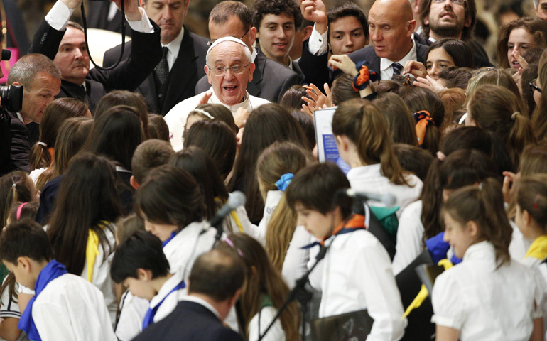 Youths surround Pope Francis as he meets with students from Jesuit schools June 7 in Paul VI hall at the Vatican. (CNS photo/Max Rossi, Reuters)