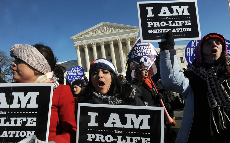 Young people hold signs outside the U.S. Supreme Court building during the March for Life on Wednesday in Washington. (CNS/Leslie Kossoff)