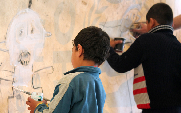 Syrian children at the Zaatari refugee camp draw pictures of themselves saying "hello." (CNS/Dale Gavlak) 