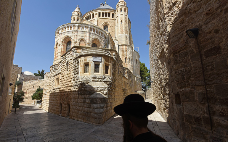An Ultra-Orthodox Jew walks past the Dormition Abbey on Mt. Zion on Monday in Jerusalem. (CNS/Debbie Hill)