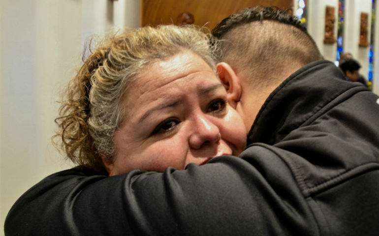 Consuelo Lopez gets a hug from her son, Pedro Lopez Vega, on May 11, 2018, at the interfaith prayer service to commemorate the immigration raid in Postville, Iowa, in 2008. Lopez was among those arrested and deported, but was able to get a visa and return to the United States about a year later. (GSR photo/Dan Stockman)