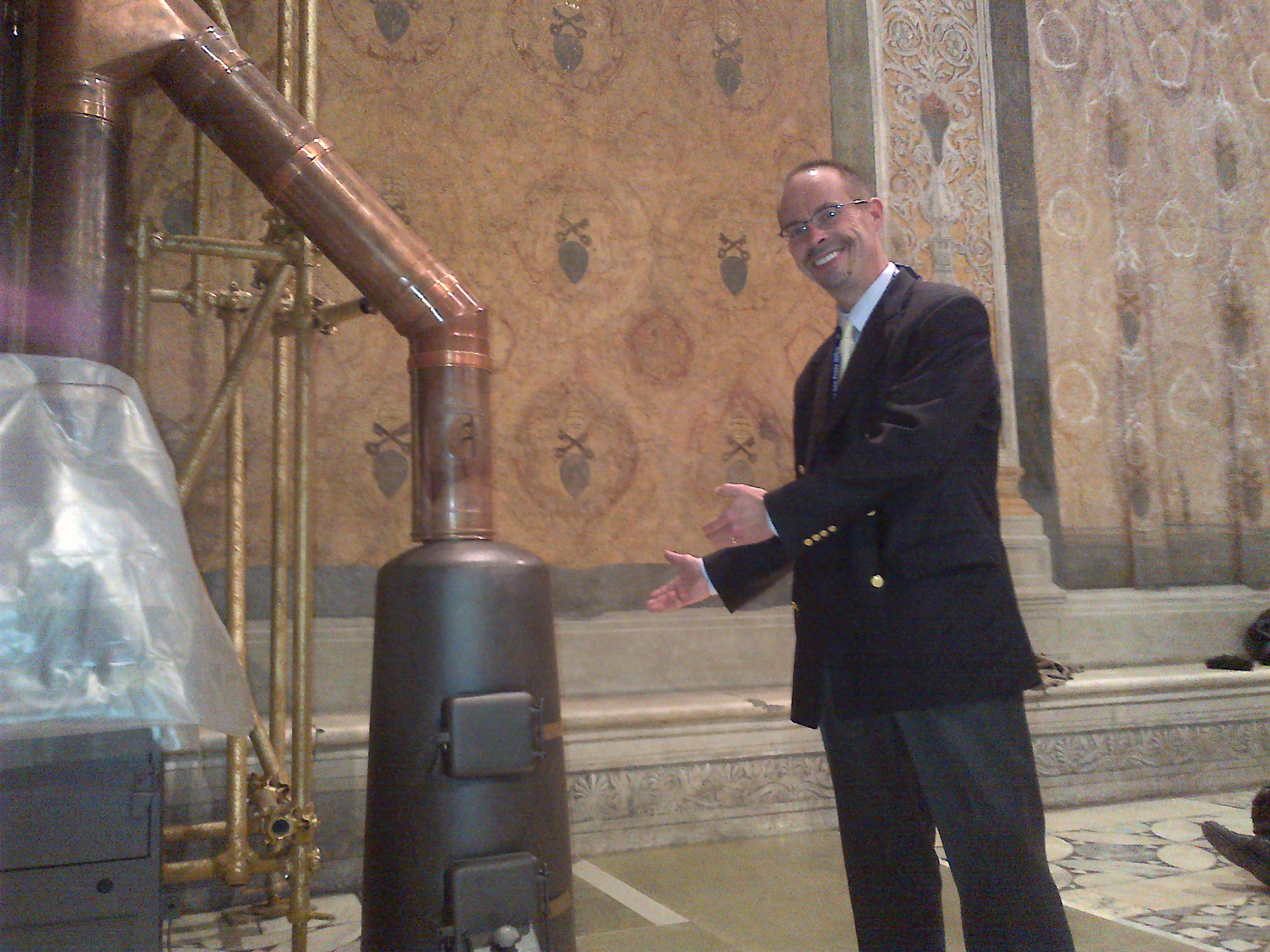 NCR senior correspondent John Allen shows off the famous stove in the Sistine Chapel