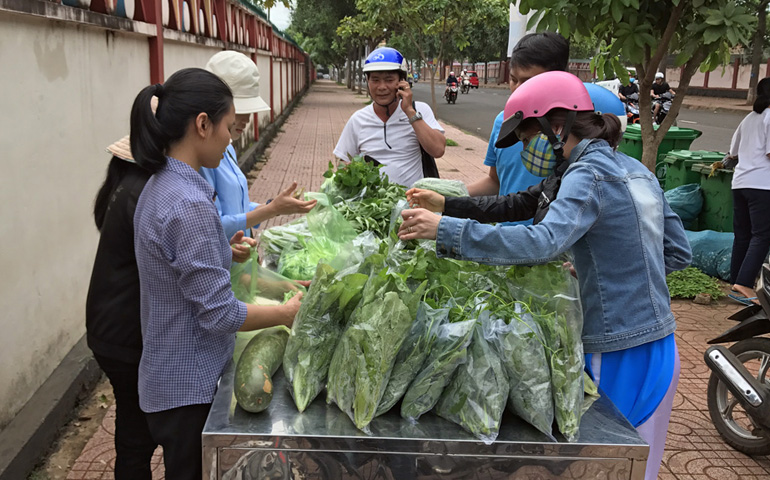 People buy organic vegetables in front of a convent of the Mary Queen of Peace Congregation in Buon Ma Thuot City. (Joachim Pham)