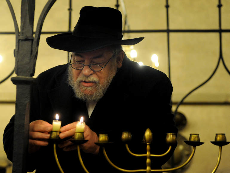 Czech Rabbi Karol Efraim Sidon lights the menorah of Hanukkah inside The Old New Synagogue, in Prague in 2010, CNS file photo.