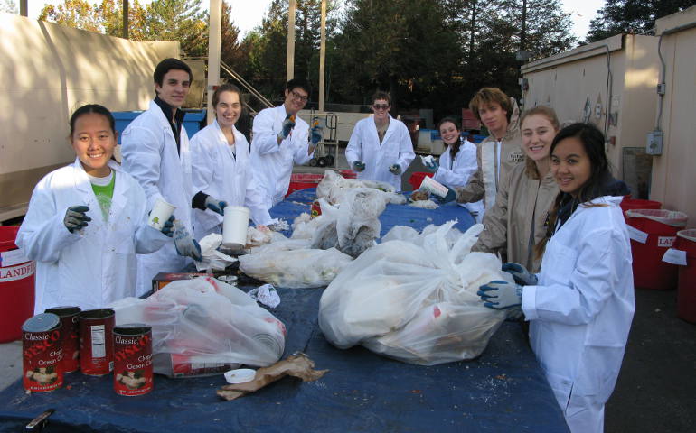 Santa Clara University students in November 2014 participate in a quarterly "waste characterization" session at a campus recycling center to get a better understanding of recycling and composting. Since 2004, Santa Clara has ramped up sustainability efforts on the Jesuit campus. (Santa Clara University)