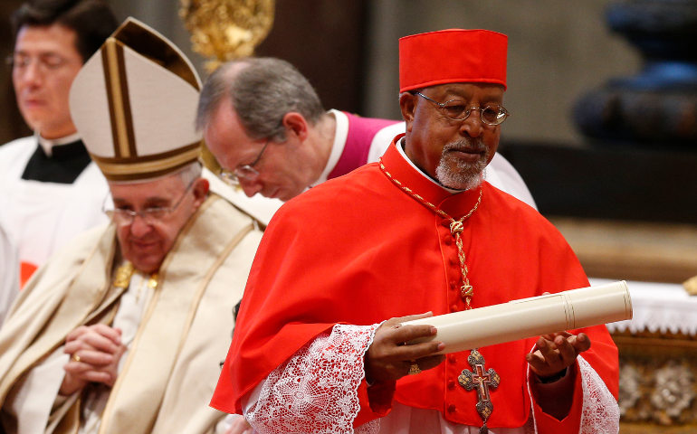 New Cardinal Berhaneyesus Souraphiel of Addis Ababa, Ethiopia, carries his scroll after receiving his red biretta from Pope Francis in St. Peter's Basilica Feb. 14. (CNS/Paul Haring)
