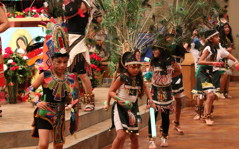 The junior troupe of St. Jerome Parish Aztec dancers perform at the church. Instructor-choreographer Claudia Gonzalez feels strongly about passing on such traditions to youngsters. (Courtesy of St. Jerome Parish)