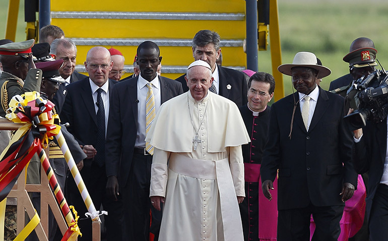 Pope Francis is welcomed by Ugandan President Yoweri Museveni, right, at the international airport in Entebbe, Uganda, Nov. 27. (CNS/Paul Haring)