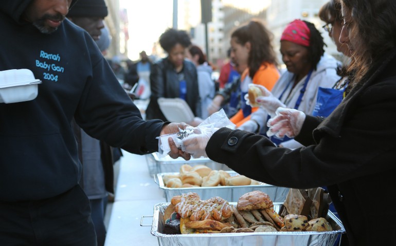 Volunteers with Catholic Charities' St. Maria's meals program in Washington serve dinner March 8 to the homeless. (CNS photo/Chaz Muth)
