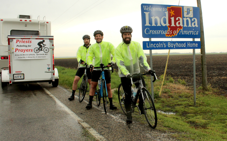 Frs. Michael Pica, Adam Cesarek and Tom Otto stand just inside Indiana April 28, bringing "Priests Pedaling for Prayers" to a close. (CNS photo/Jennifer Willems, The Catholic Post)