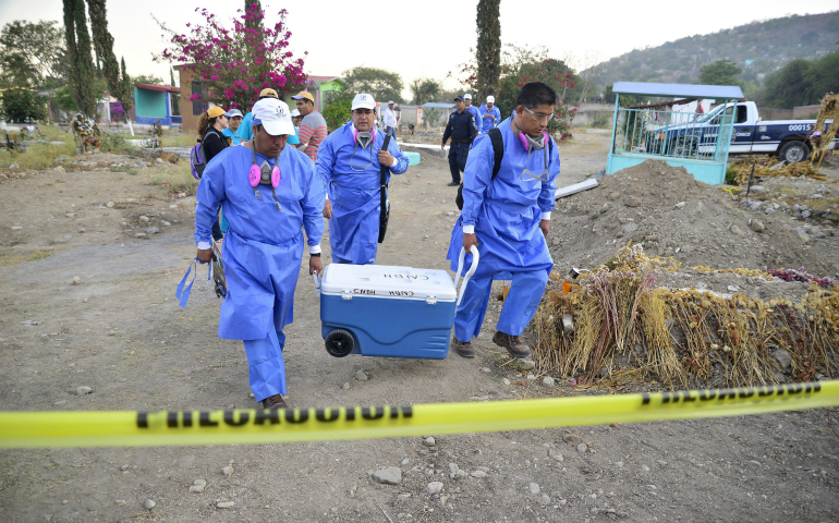 Specialists in Jojutla, Mexico, unearth remains found in unmarked graves March 21. (CNS photo/Tony Rivera, EPA)