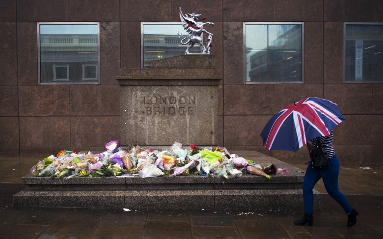 A person walks past a memorial for victims of the London Bridge terror attacks in London, June 6. Archbishop Peter Smith of Southwark, the archdiocese that covers London south of the River Thames, offered prayers for the victims, survivors and first responders. (CNS photo/Will Oliver, EPA)