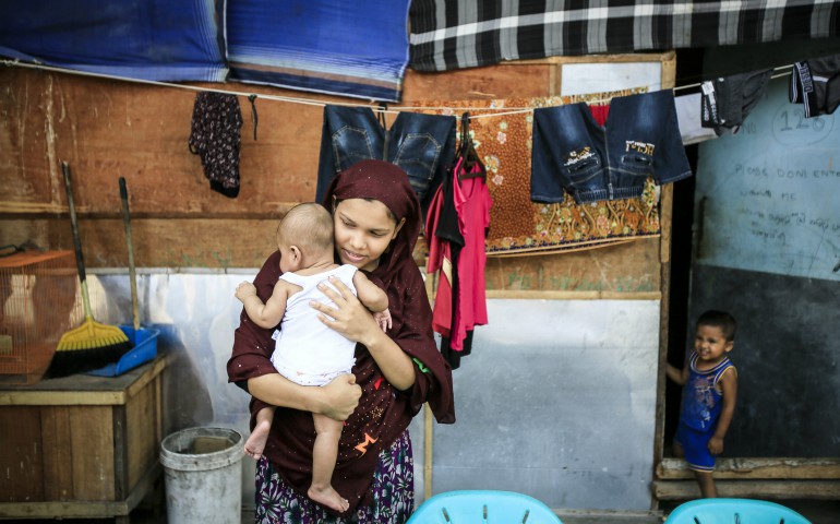 A Rohingya woman holds her 2-month-old baby in early February at a refugee shelter in Medan, Indonesia. (CNS photo/Dedi Sinuhaji, EPA)