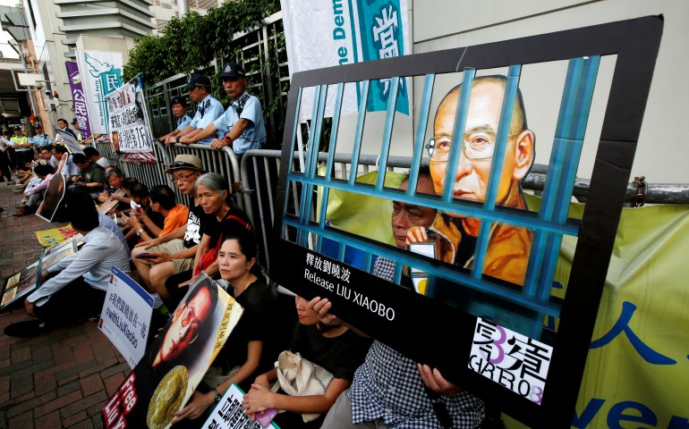 Activists stage a sit-in demanding the release of Liu Xiaobo, the 2010 Nobel Peace Prize winner, July 10 outside China's Liaison Office in Hong Kong. (CNS photo/Bobby Yip, Reuters)