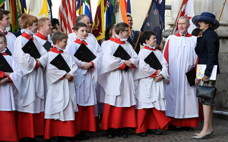 Britain's Prime Minister Theresa May, right, talks with choristers after a Commonwealth Day service at Westminster Abbey in London on March 13, 2017. (Reuters/Toby Melville)